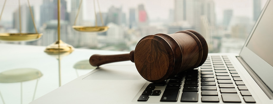 Gavel resting on a laptop keyboard