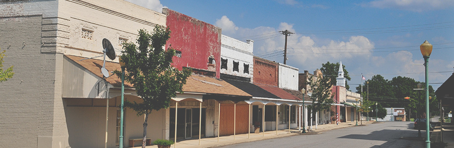 Boarded up abandoned store fronts in a small town.