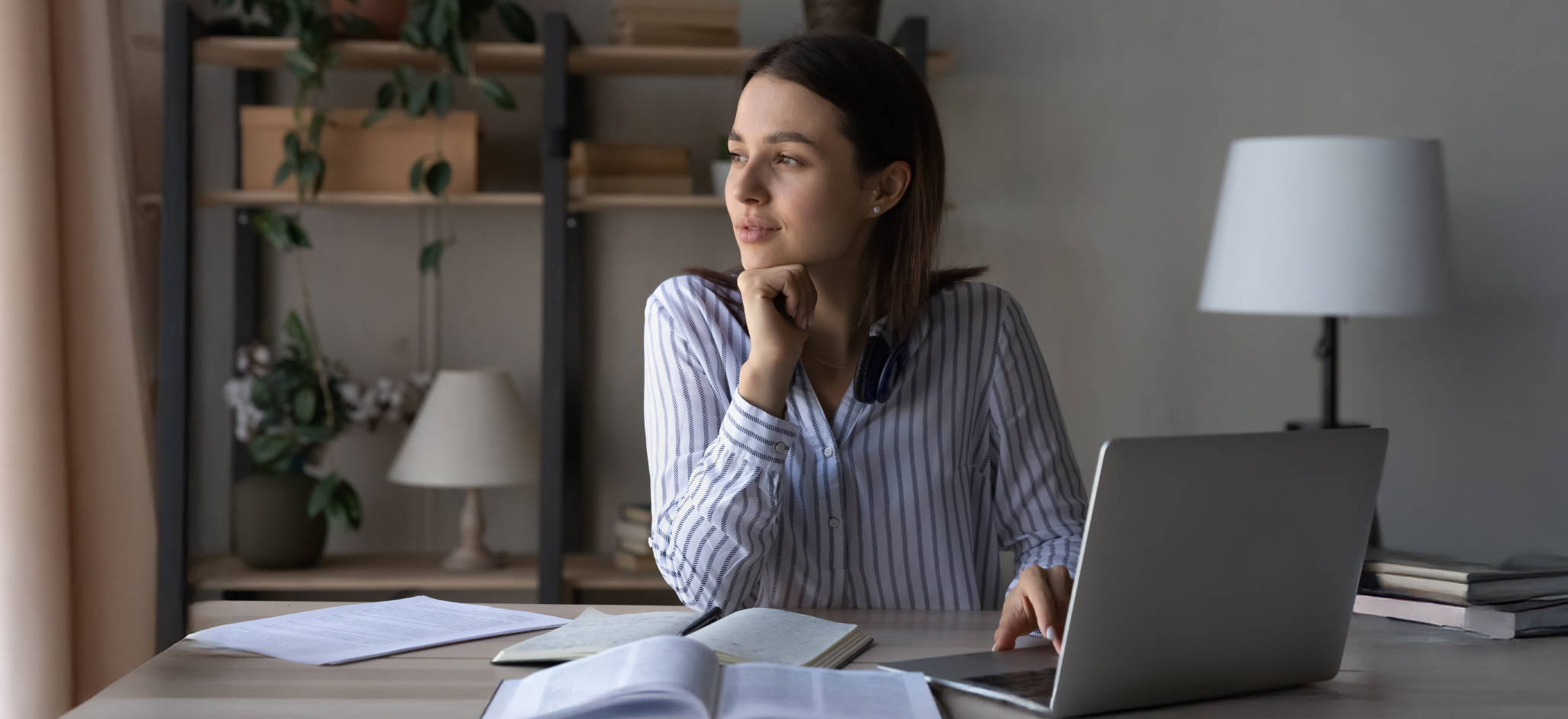 Woman In Striped Blouse Works in a Dim Office